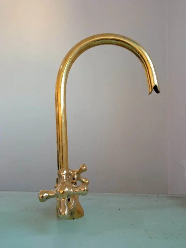 Premium brass kitchen faucet with high-arched spout and dual-handle design, perfect for modern and traditional kitchens.