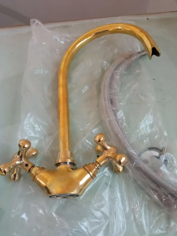 Premium brass kitchen faucet with high-arched spout and dual-handle design, perfect for modern and traditional kitchens.
