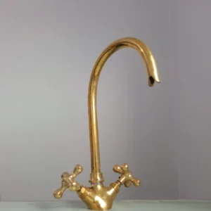 Premium brass kitchen faucet with high-arched spout and dual-handle design, perfect for modern and traditional kitchens.